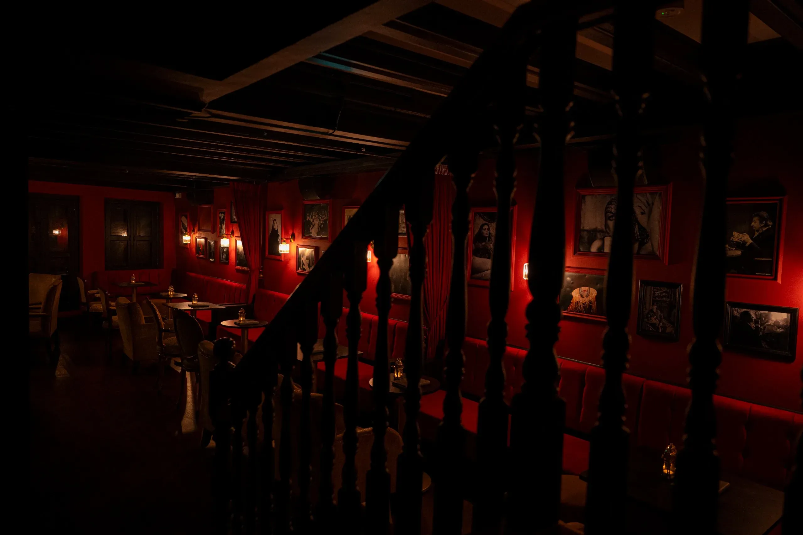 The dimly-lit red interior of Madame Claude